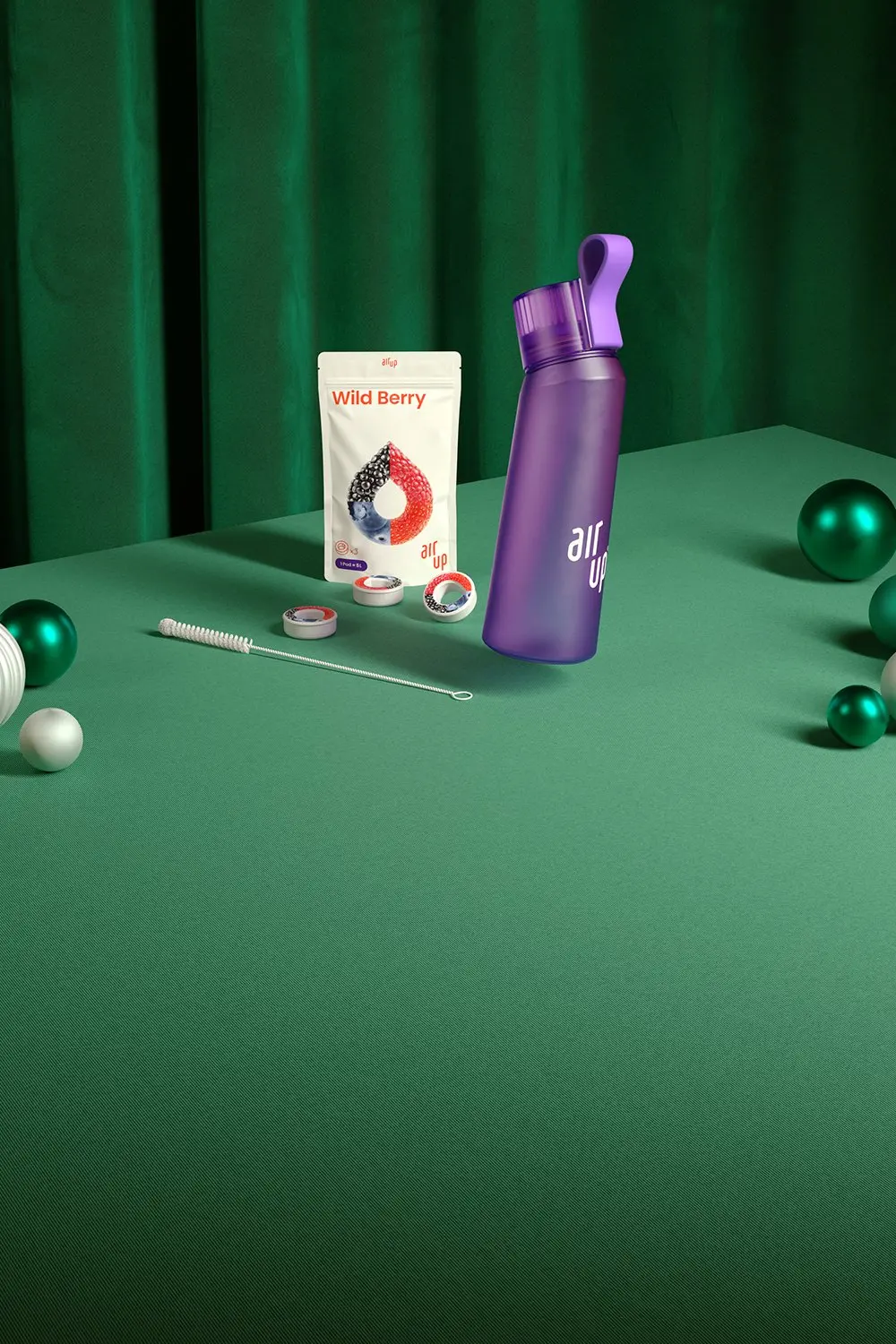 A display of air up bottles and pods on a holiday themed table